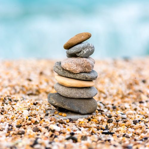 A serene scene with stacked stones, symbolizing balance and stability.